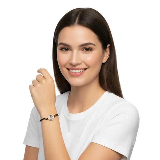 Woman wearing a silver diamond alphabet O bracelet with black cord on wrist