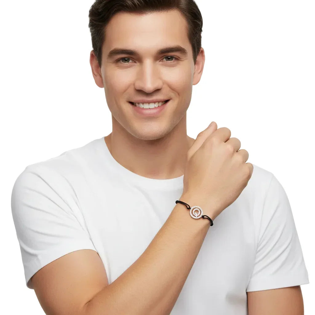 Man wearing a silver diamond alphabet Q bracelet with black cord on wrist