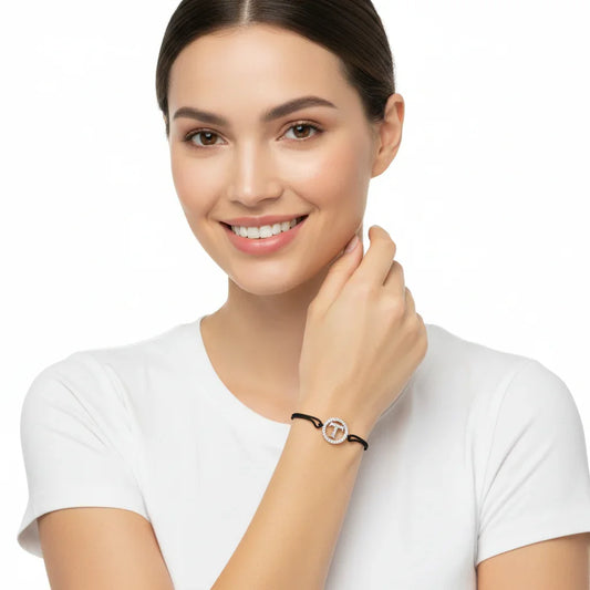 Woman wearing a silver diamond alphabet T bracelet with black adjustable cord
