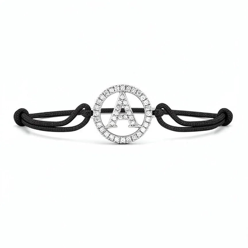 Silver diamond alphabet A bracelet with black adjustable cord on white background