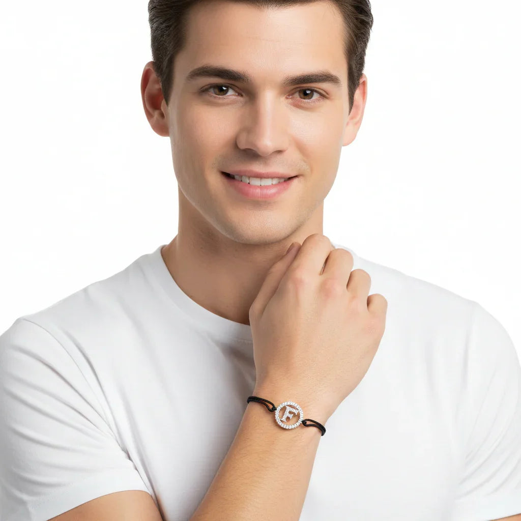 Man wearing silver diamond alphabet F bracelet with black adjustable strap