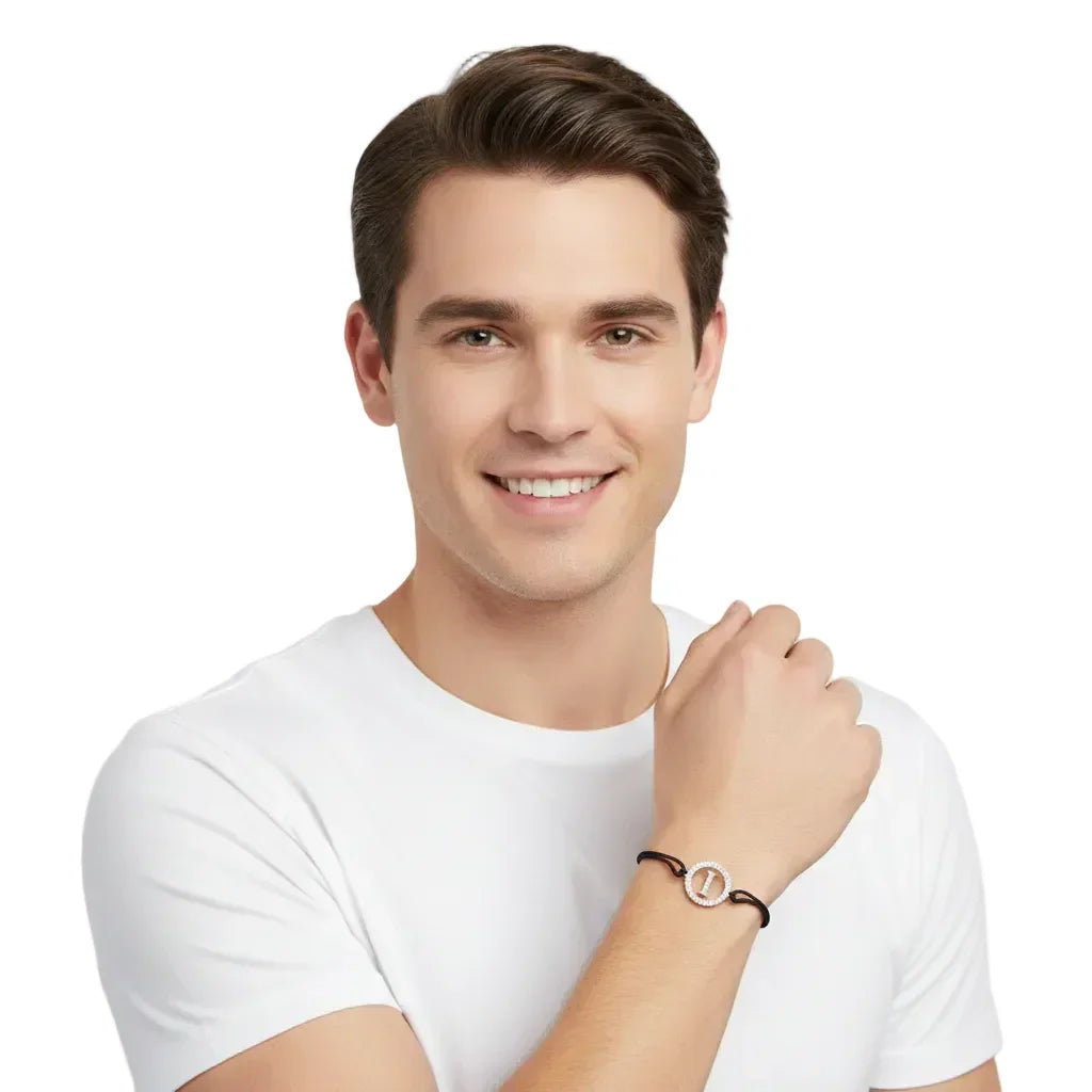 Man wearing a silver diamond letter I bracelet with black cord on wrist