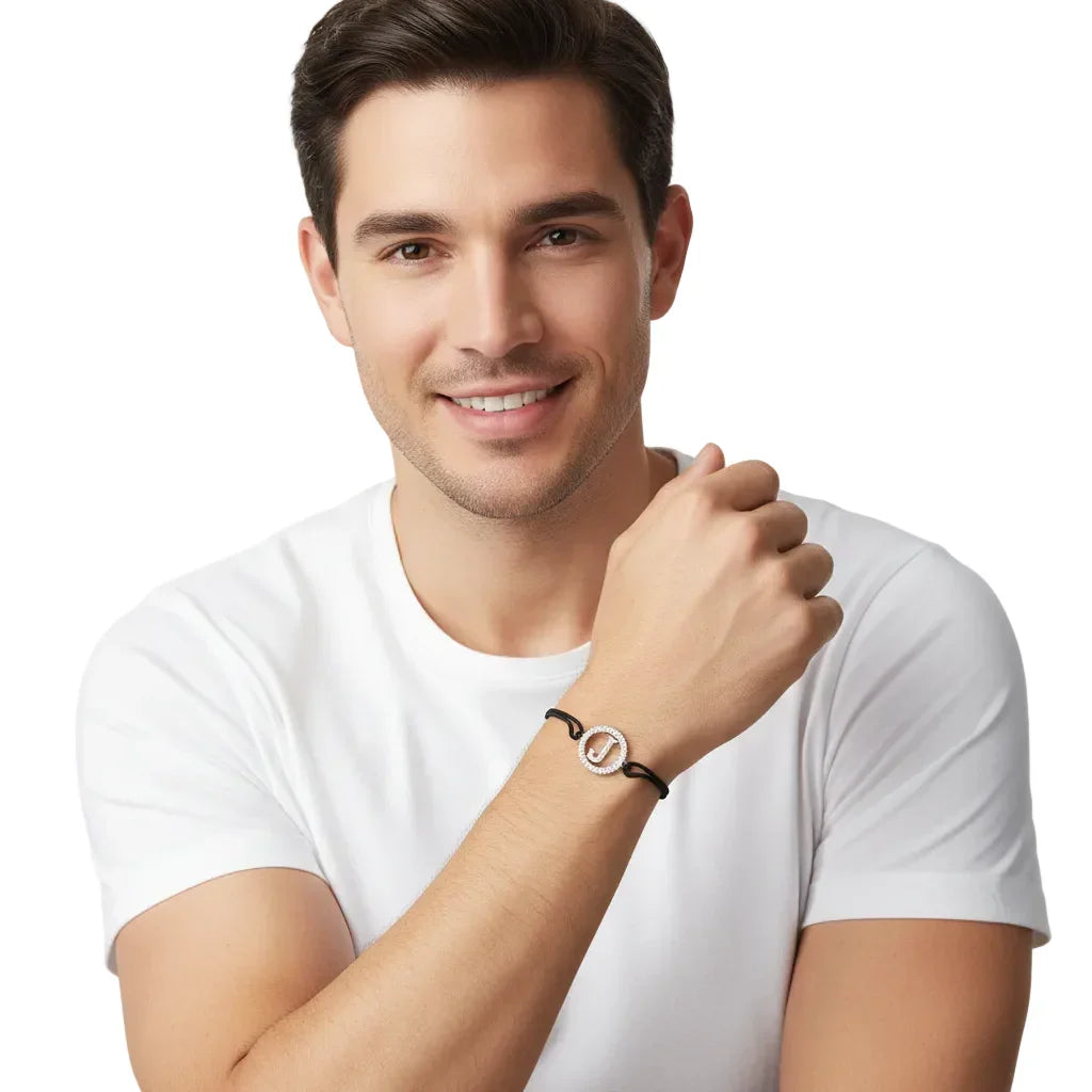 Smiling man wearing a white t-shirt and a diamond letter J bracelet on black cord.