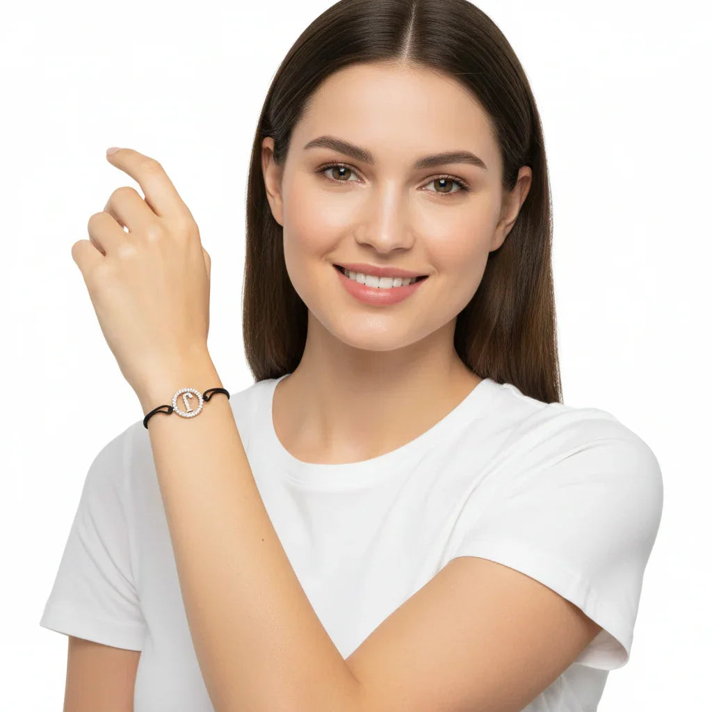 Woman wearing silver diamond alphabet J bracelet with black adjustable cord