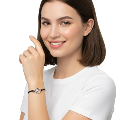 Woman wearing silver diamond alphabet K bracelet with black cord on wrist