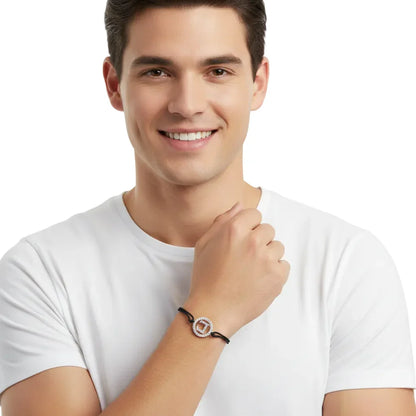Man wearing a diamond alphabet L bracelet with silver setting on black cord