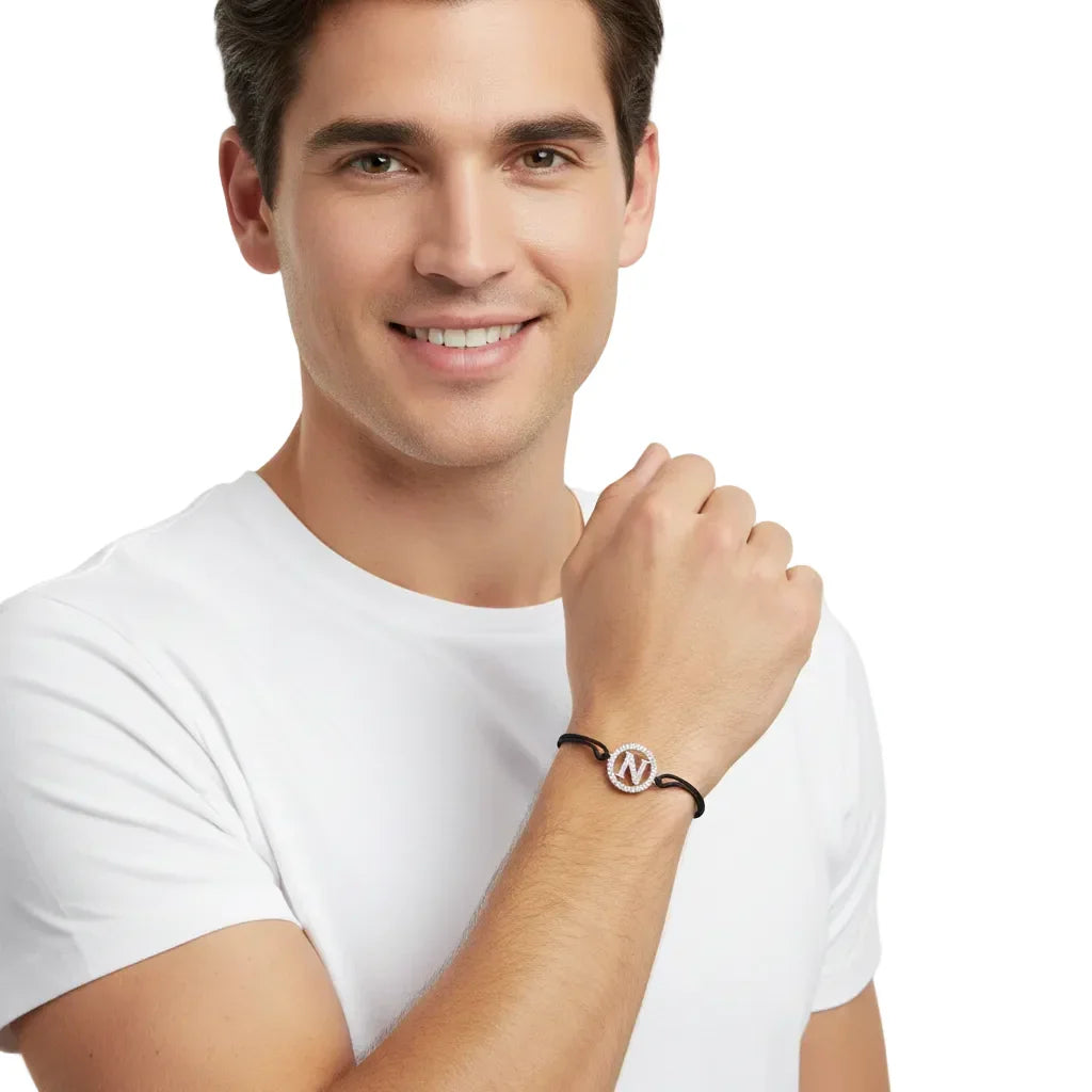 Diamond letter N bracelet in silver with adjustable black cord, displayed on a man's wrist