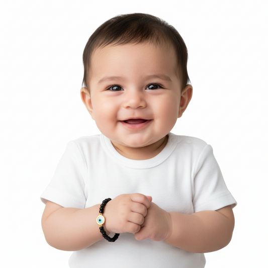 Om & Evil eye charm in gold on black beads for new born - Jewelslane