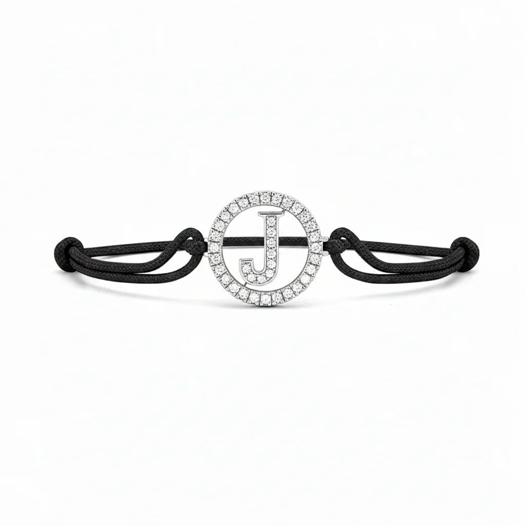 Black cord bracelet with diamond-studded initial J charm, minimalist jewellery design