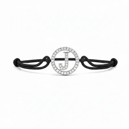 Black cord bracelet with diamond-studded initial J charm, minimalist jewellery design