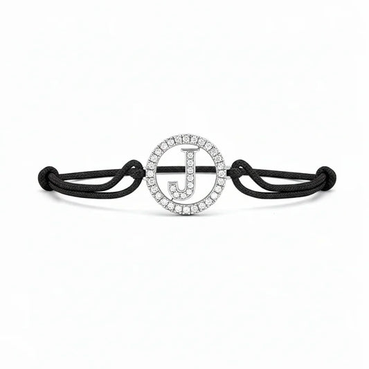 Black cord bracelet with diamond-studded initial J charm, minimalist jewellery design