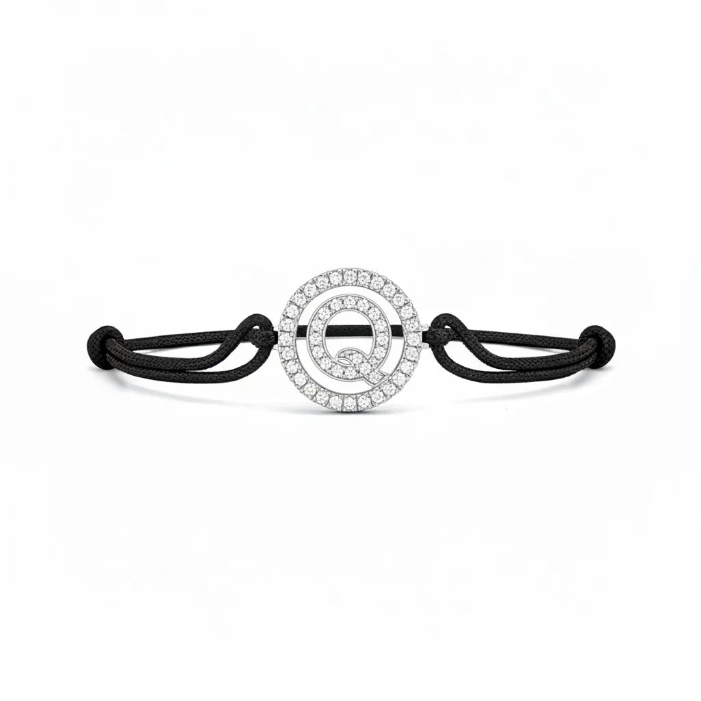Silver diamond Q letter bracelet with black adjustable cord on white background