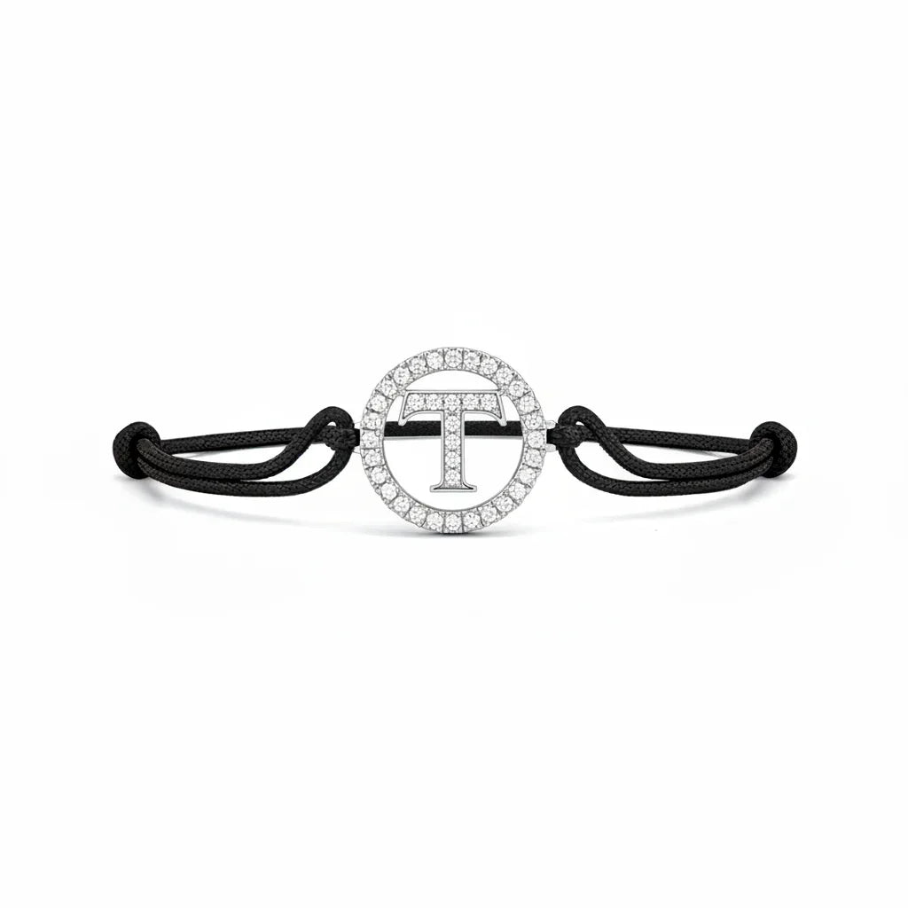 Silver diamond alphabet T bracelet with black adjustable cord on white background