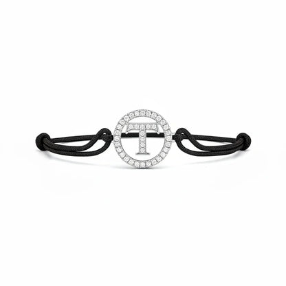 Silver diamond alphabet T bracelet with black adjustable cord on white background