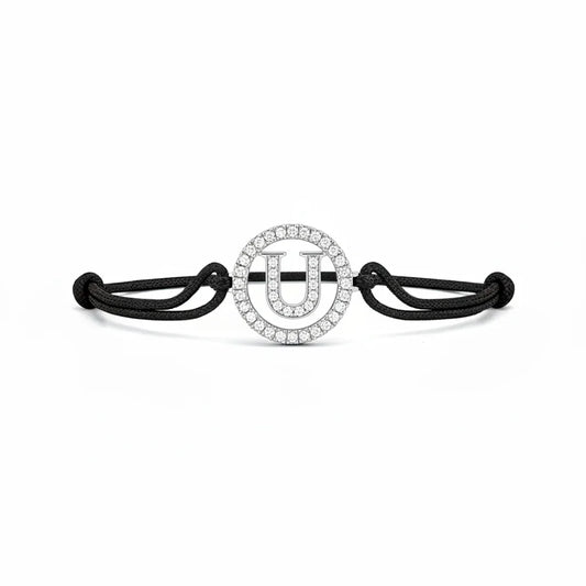 Silver diamond alphabet U bracelet with black adjustable cord on white background
