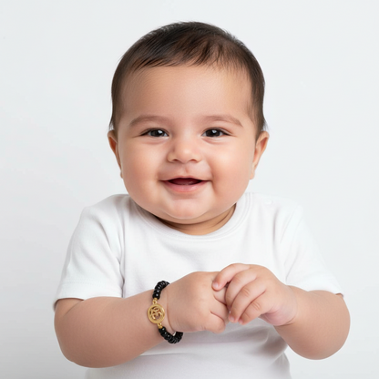 Om & Evil eye charm in gold on black beads for new born